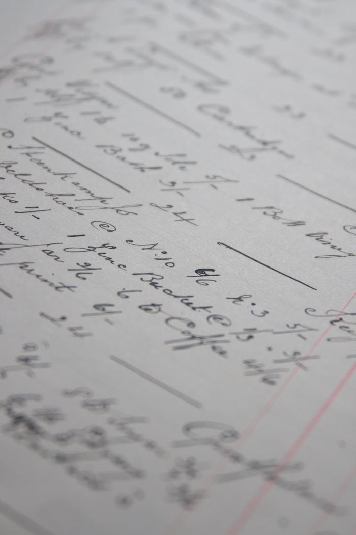 Detailed close-up of handwritten text and lines on paper showcasing cursive writing.