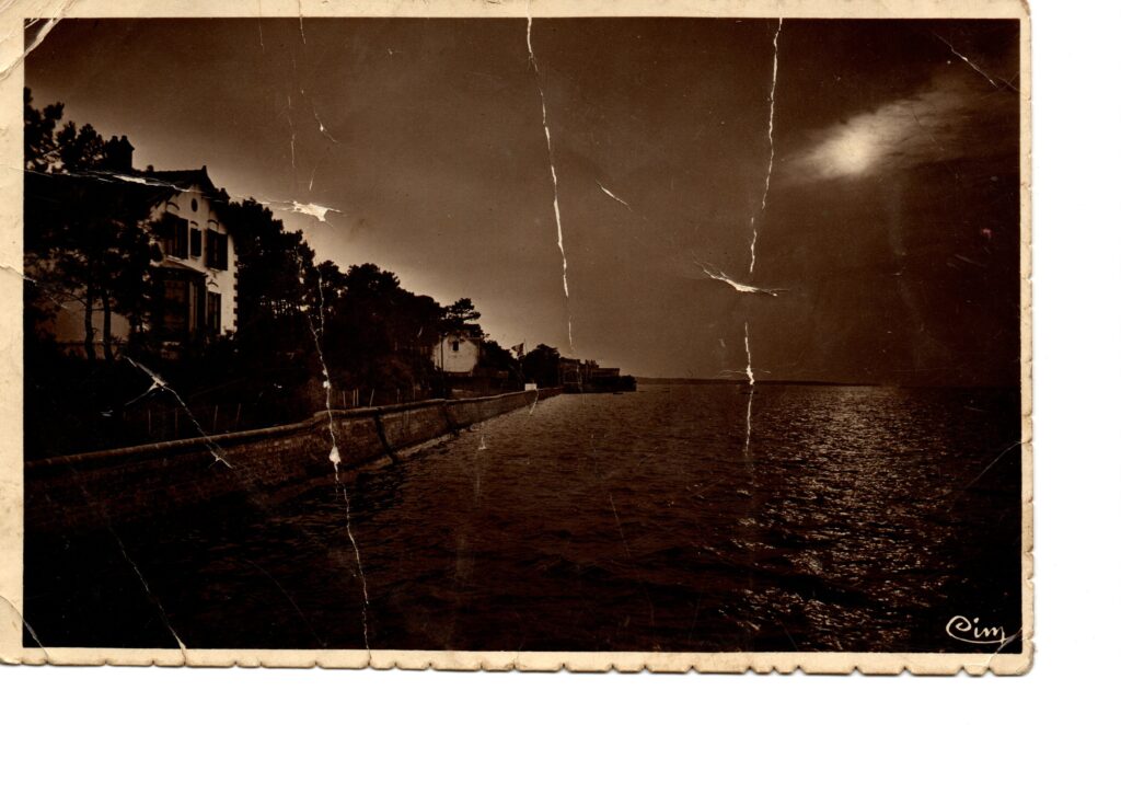 Carte postale ancienne de Ronce-les-Bains montrant un coucher de soleil sur l’océan le long de la digue et des villas.